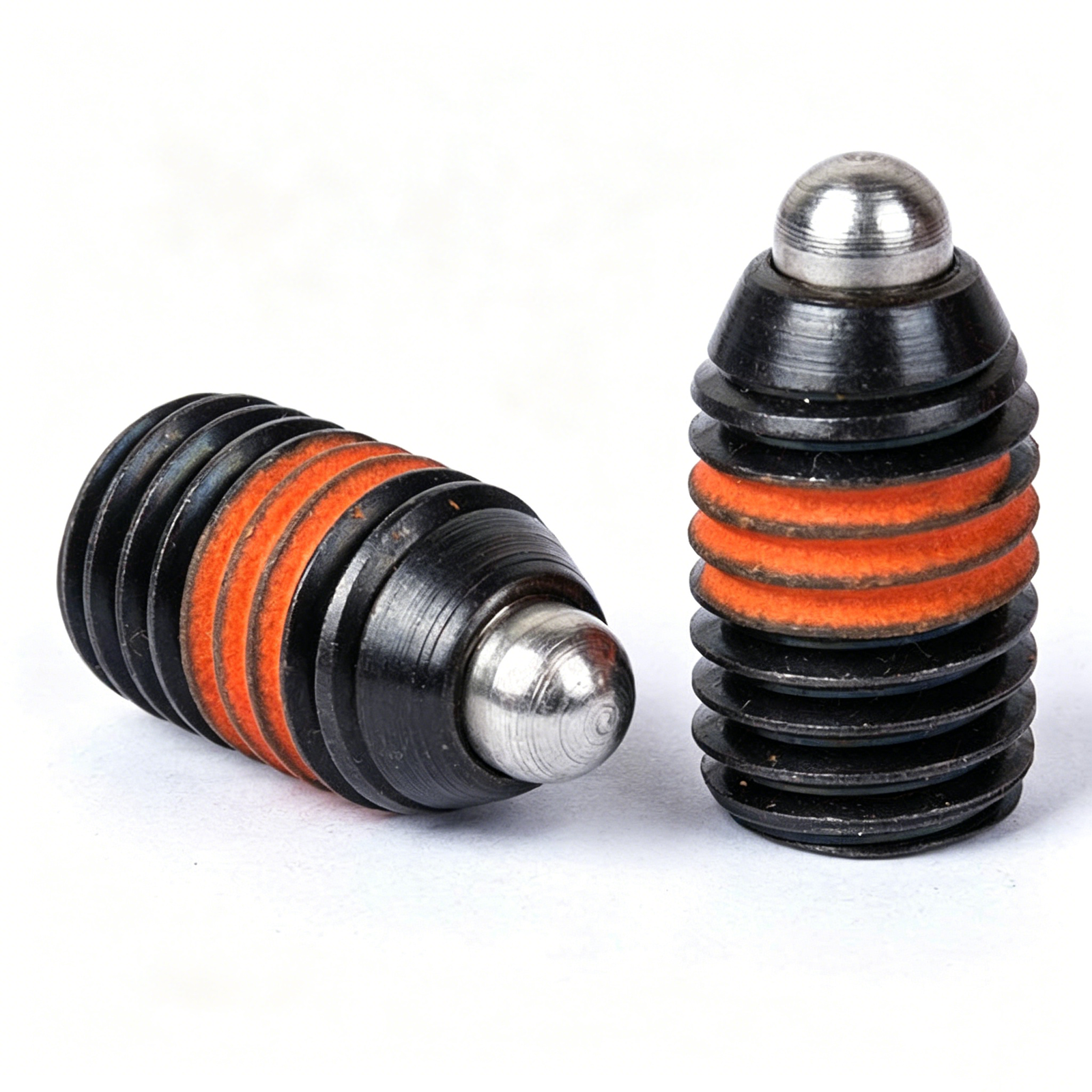 Comparative view of carbon steel pin versus non-marring POM nose indexing plungers showing internal spring mechanisms.